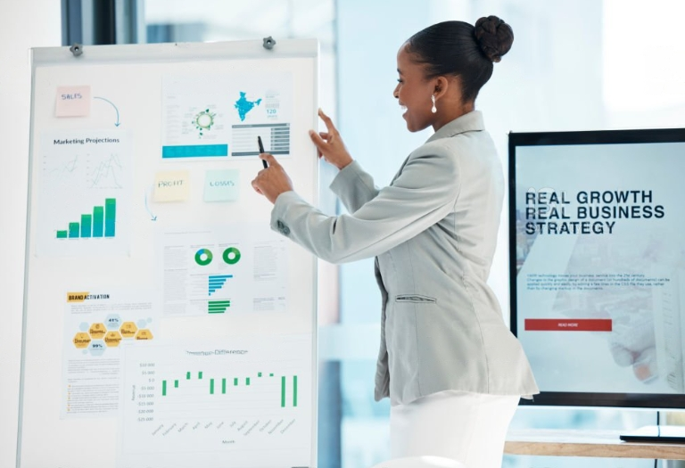 Black woman standing in front of data visualization table